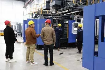 Engineers and customers reviewing a machine on the shop floor