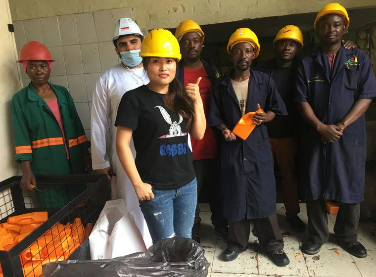 Factory visitors wearing safety helmets