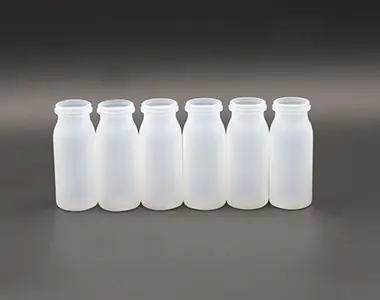 Linked white wide-neck bottles before trimming