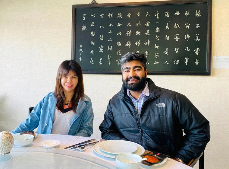 Two visitors seated at a meeting table