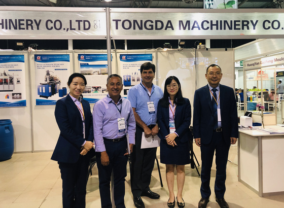 Visitors at a machinery exhibition booth