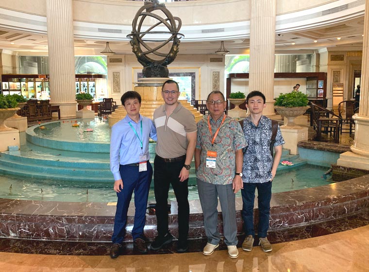 Visitors posing in a building lobby