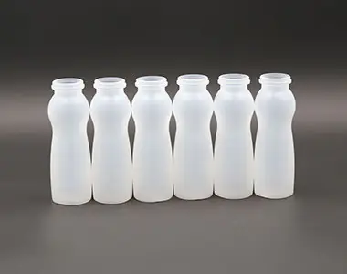 White curved plastic milk bottles